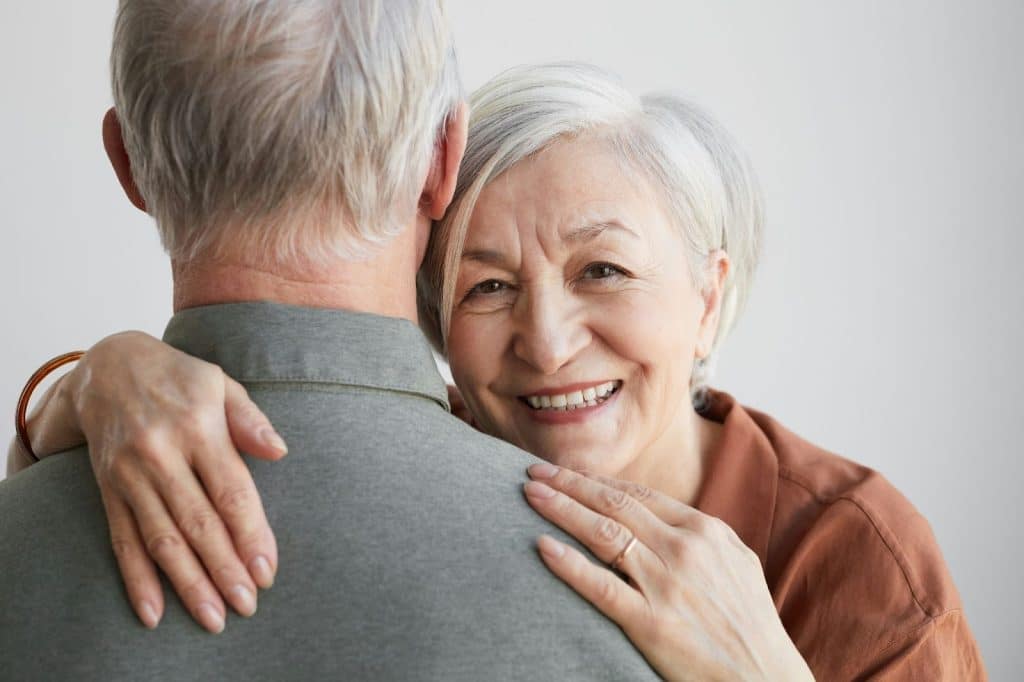 A man hugging a woman