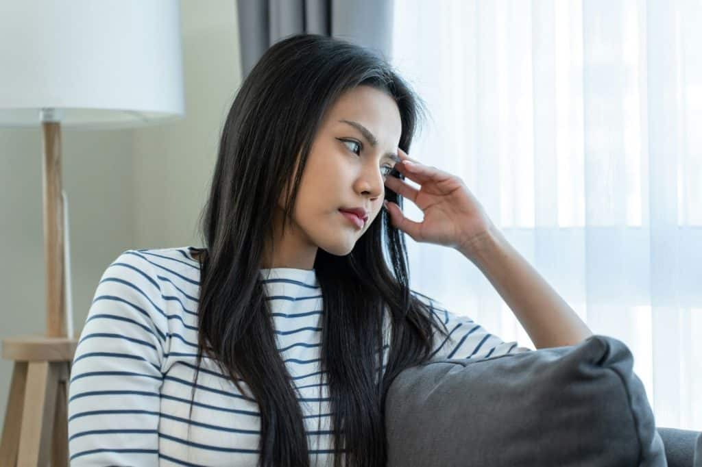 A woman keeping herself silent 