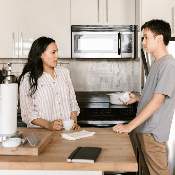 A couple talking in the kitchen