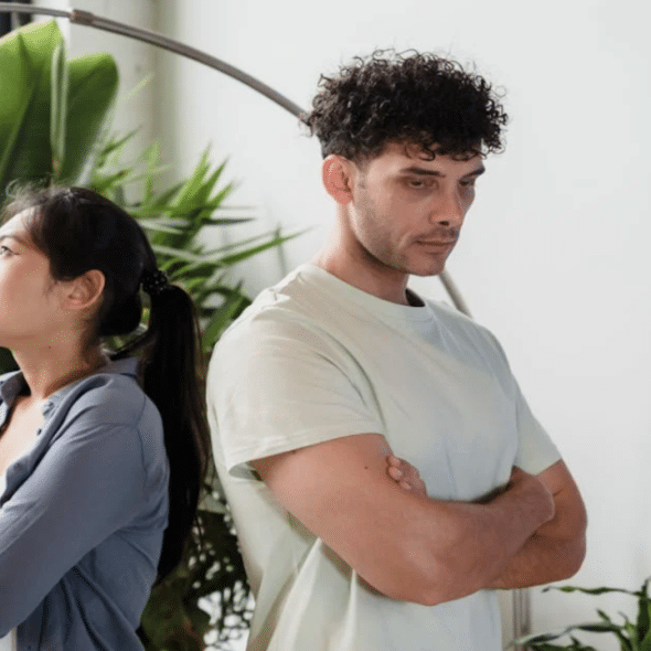 A couple refusing to look at each other by the window
