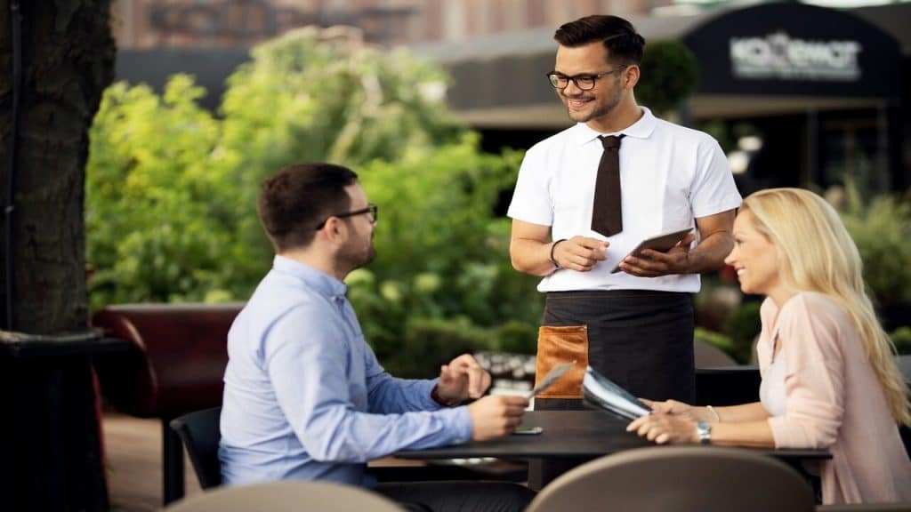 A couple talking to a waiter