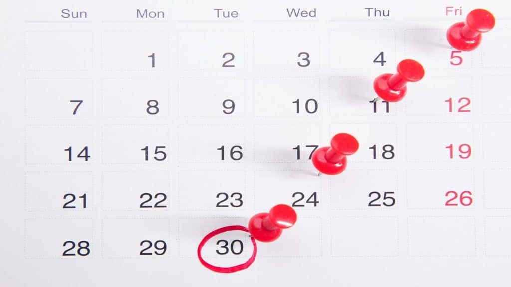 Red buttons pinned to a calendar