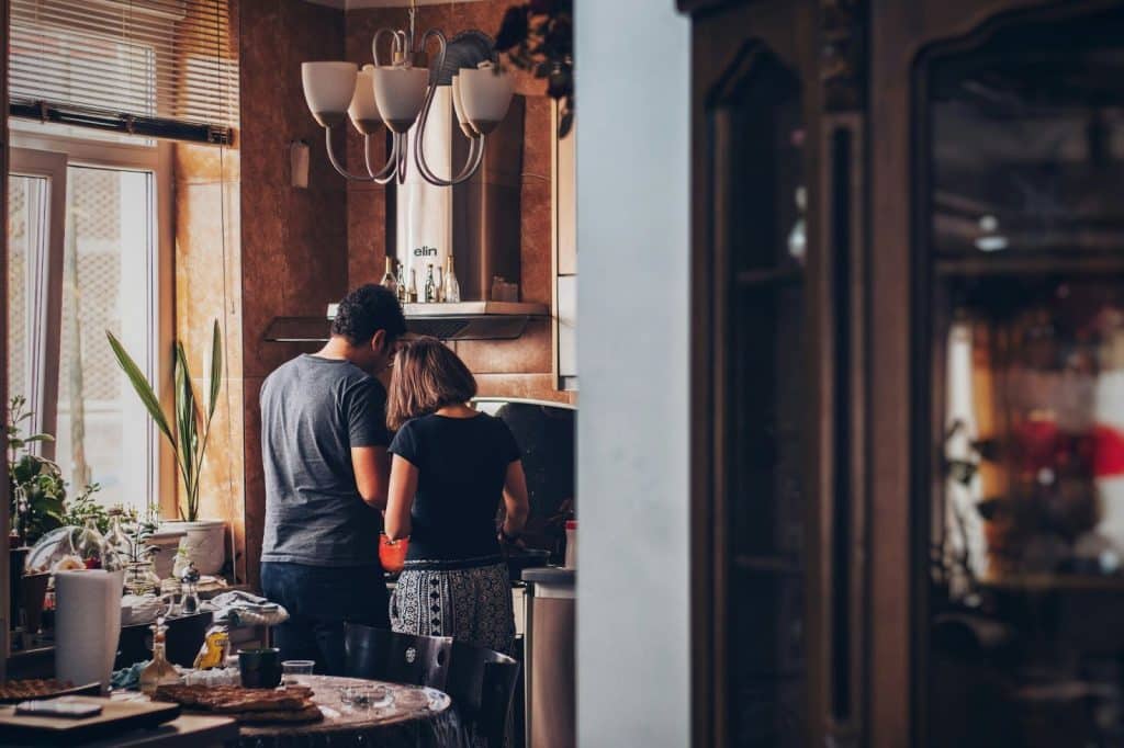 A man and woman at the kitchen