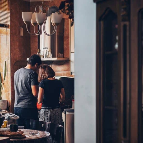 A man and woman at the kitchen