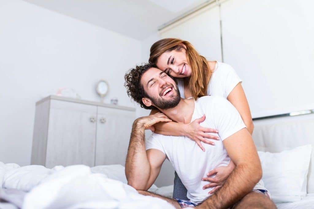 A woman hugging a man