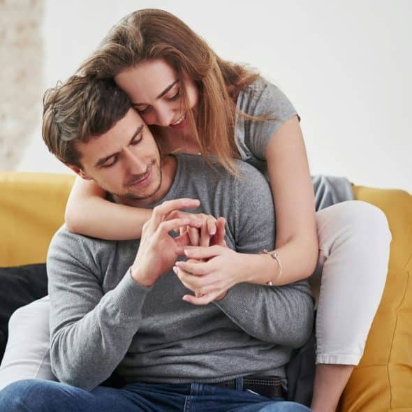 A man and woman hugging each other