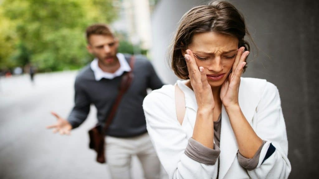 A man forcing his girlfriend to talk