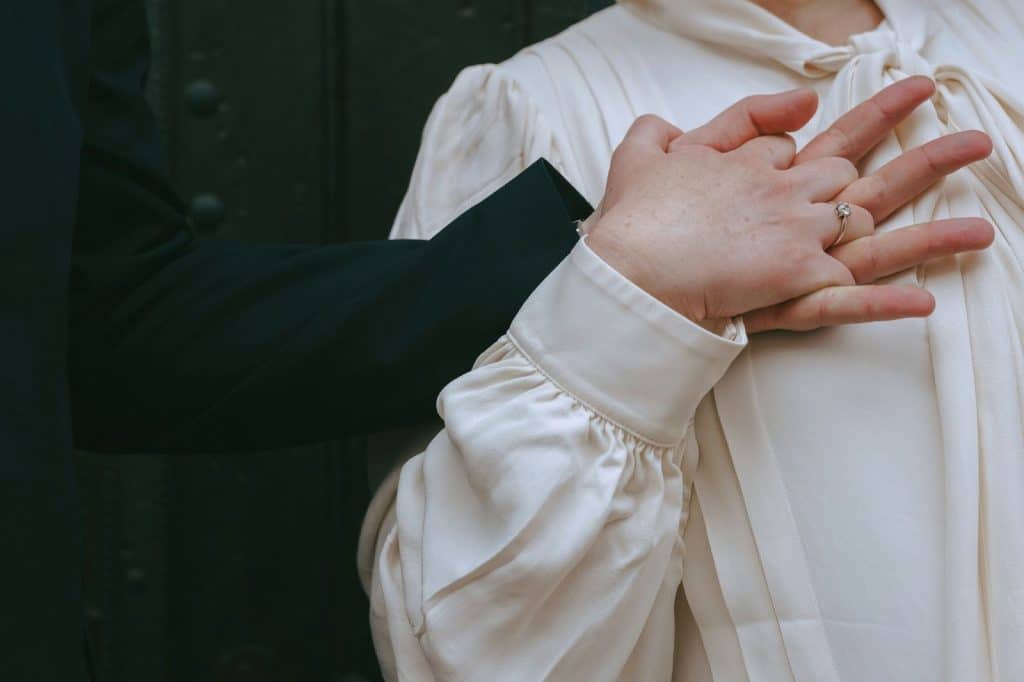 A man holding a woman’s hand