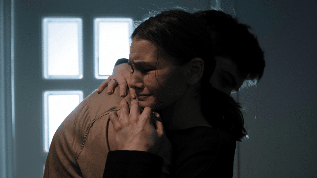 A man comforting his sad wife
