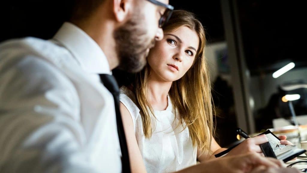 A woman giving a concerned look toward a man during a discussion.