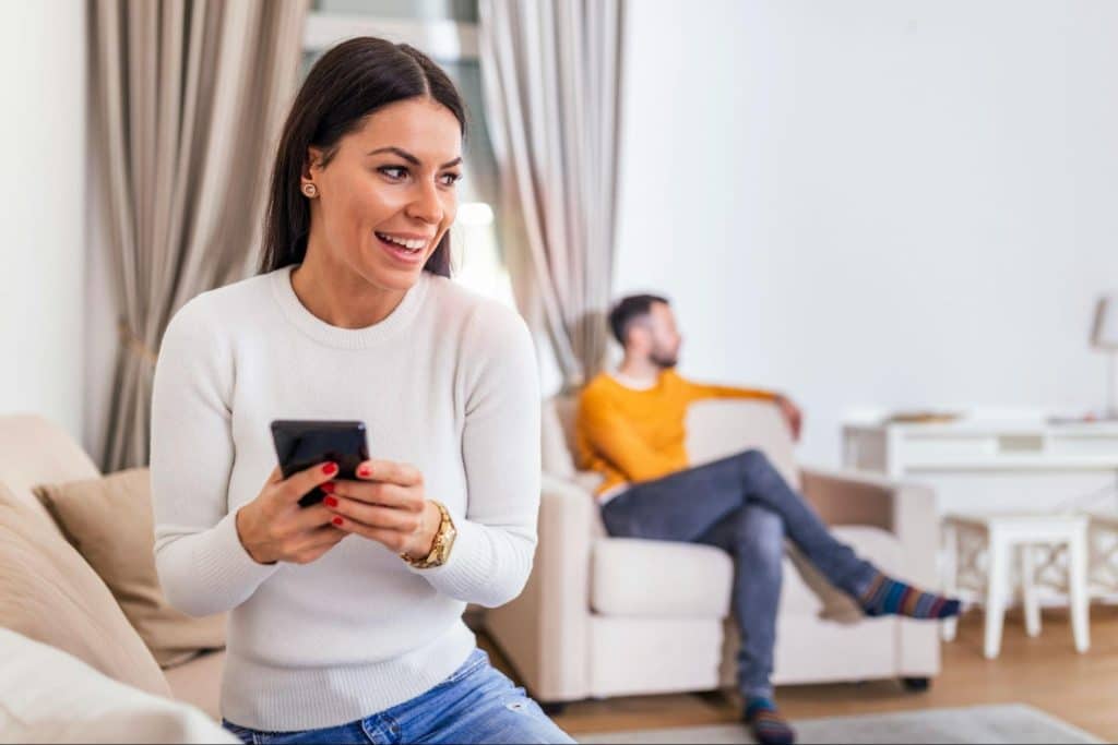 A woman doing something with her phone 