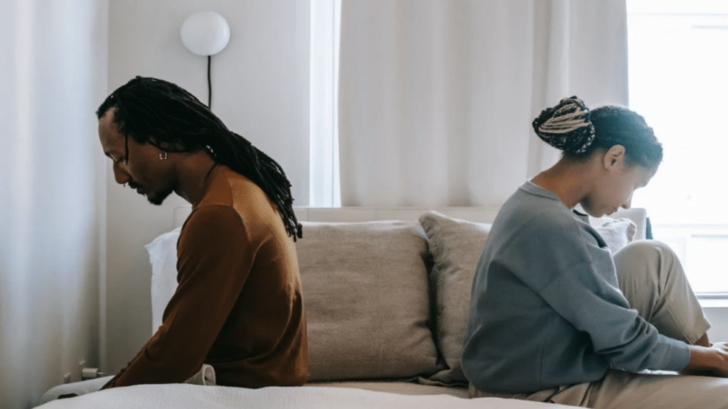 A couple looking sad in bed