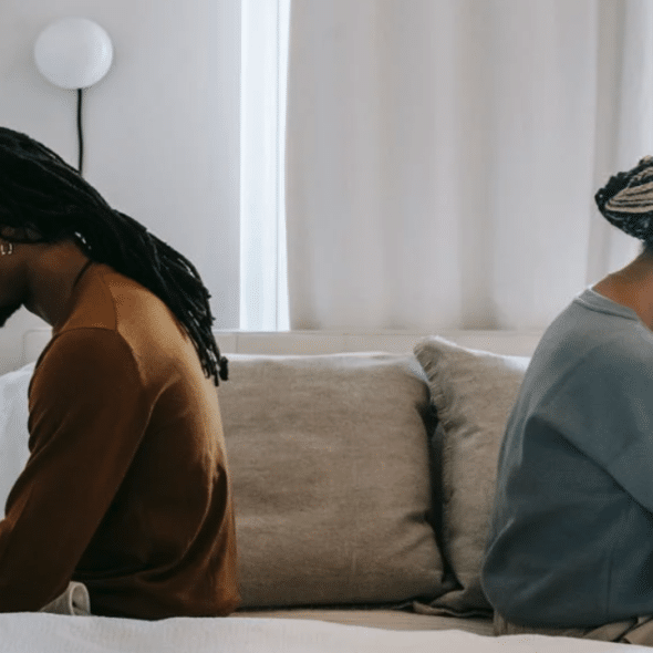 A couple looking sad in bed