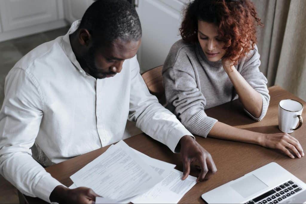 A man and woman looking at the document
