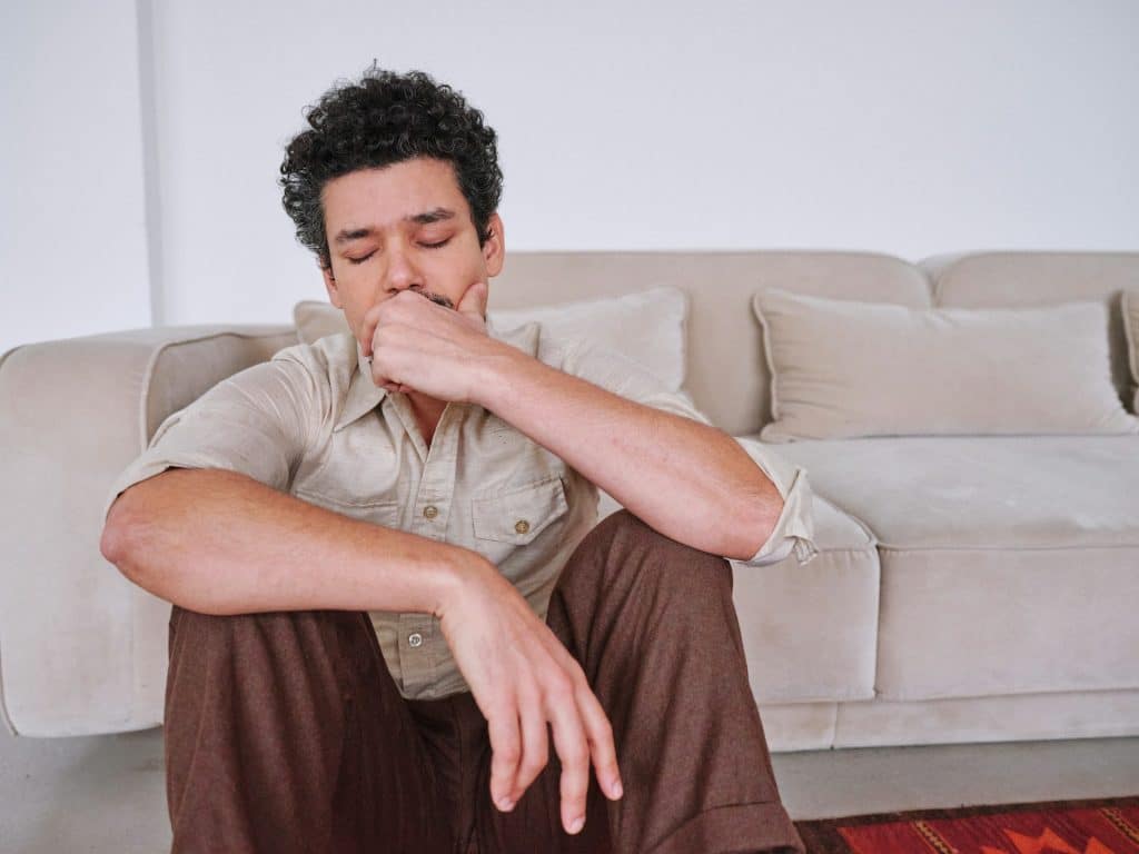 A man sitting on the floor.