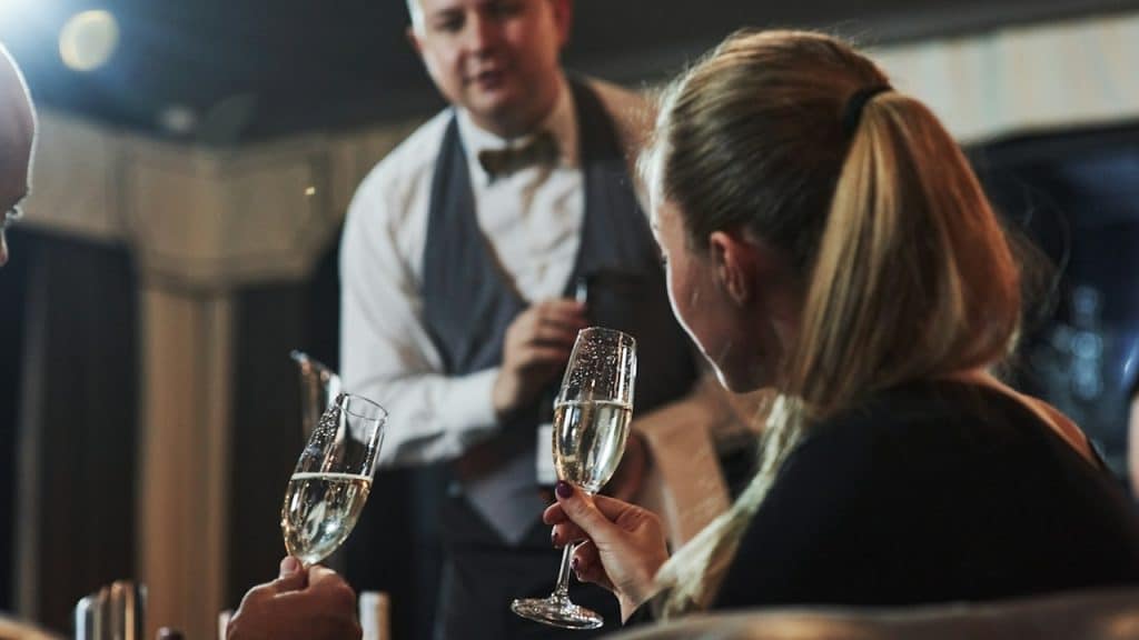 A girl making an order with her boyfriend at a beautiful restaurant.