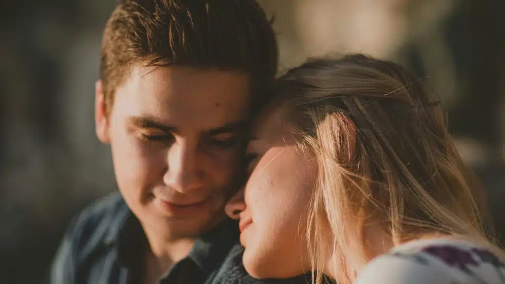 A woman resting her head on a man’s shoulder.
