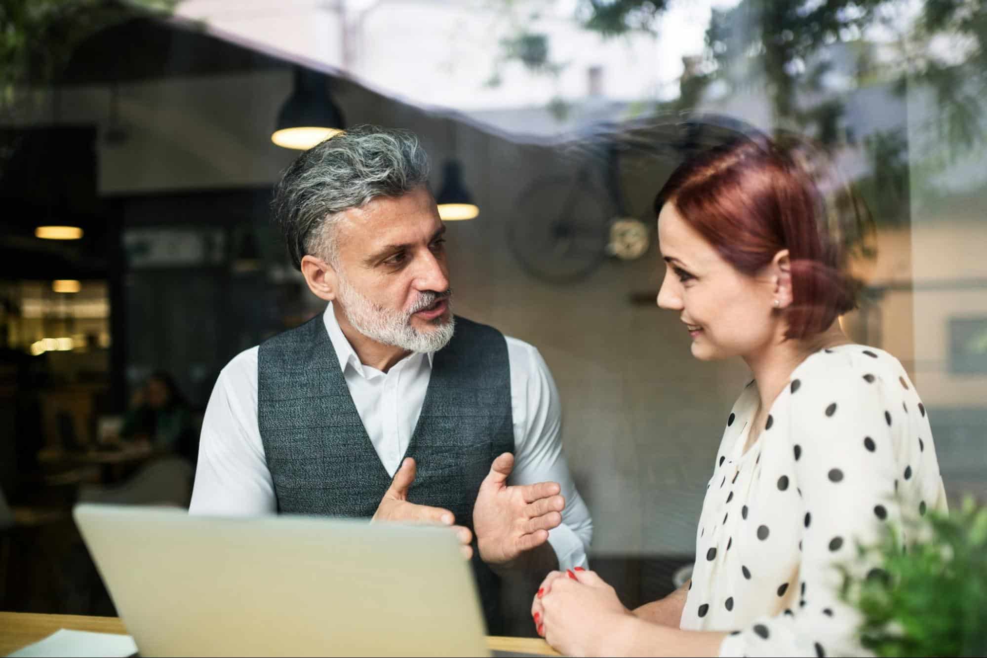 A man explaining something to woman