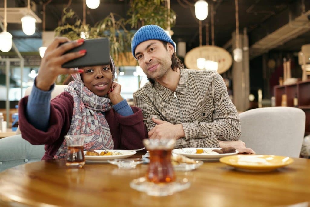 A couple taking a selfie in the restaurant.