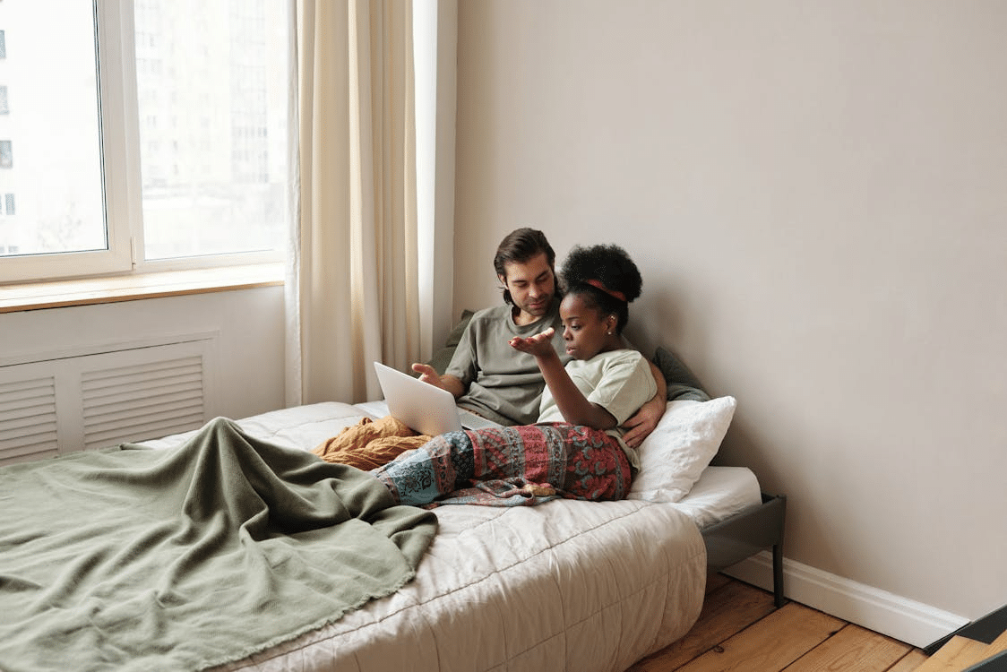 A couple lying on the bed
