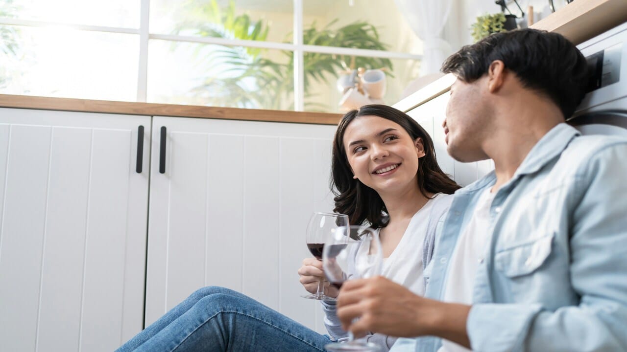 A couple having wine together at home
