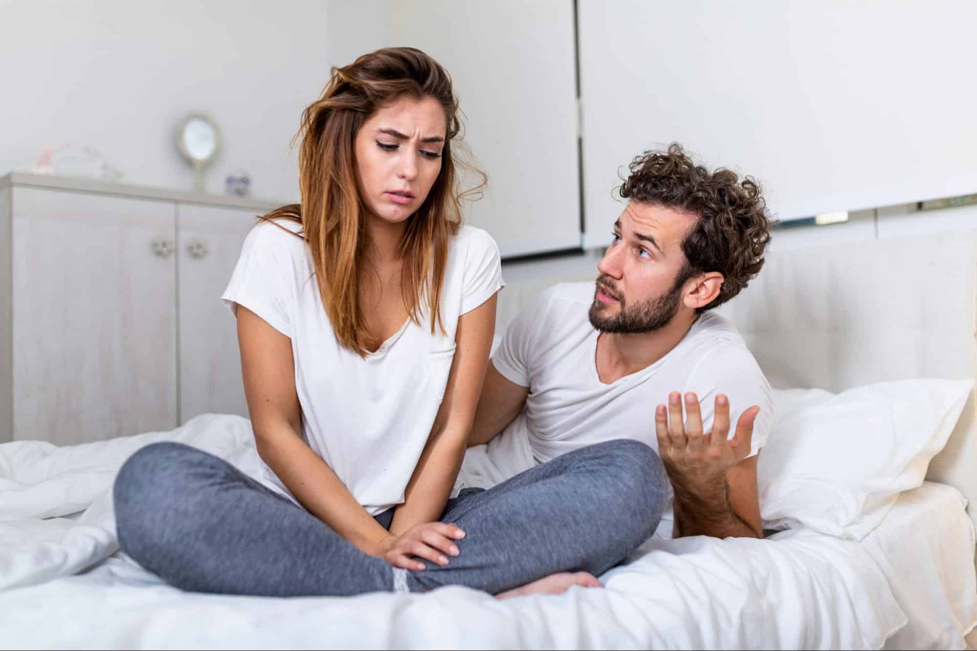 A man saying something to woman
