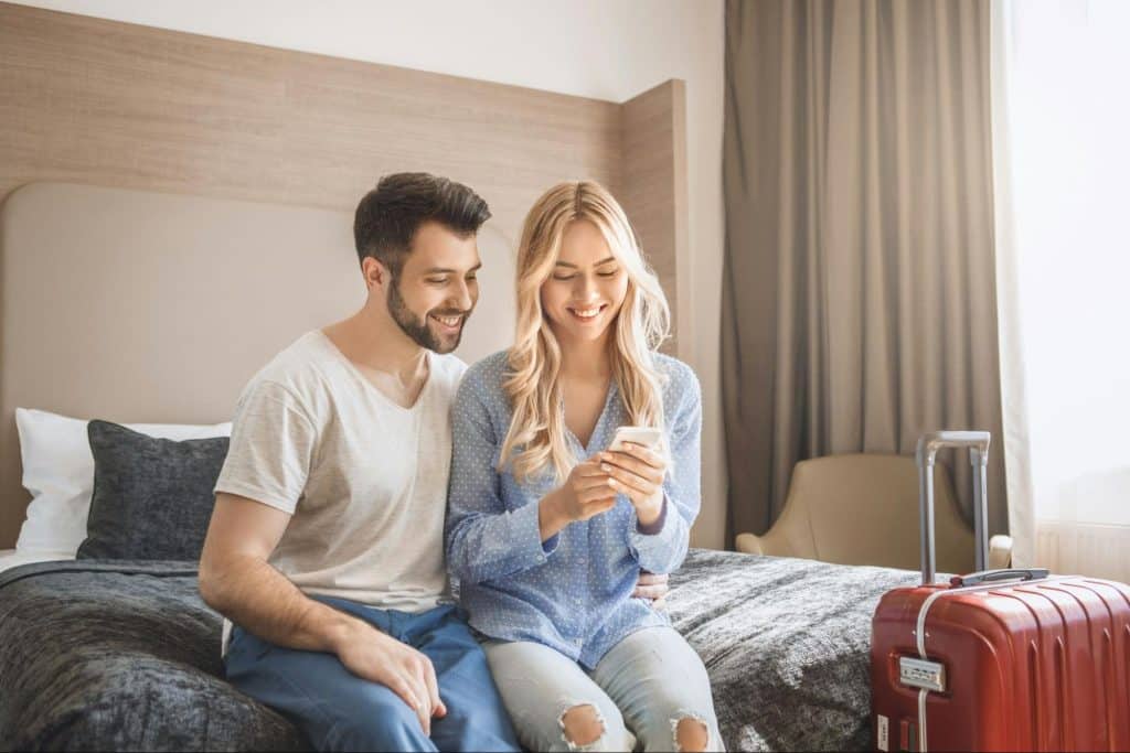 A woman holding a phone and a man beside her