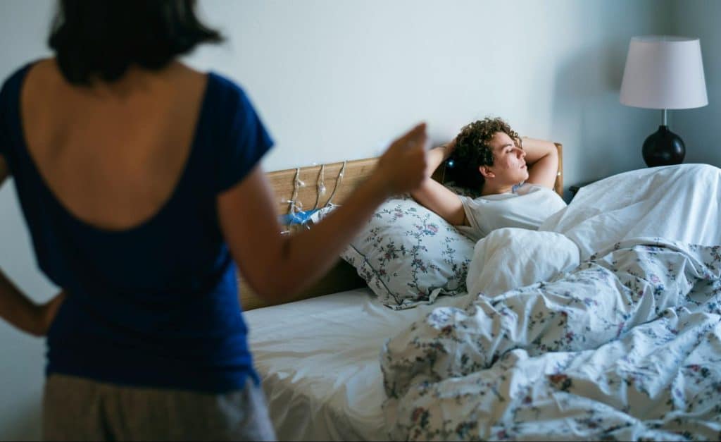 A woman observing a man