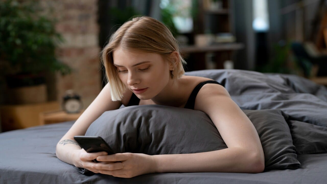 A woman looking sad while texting 