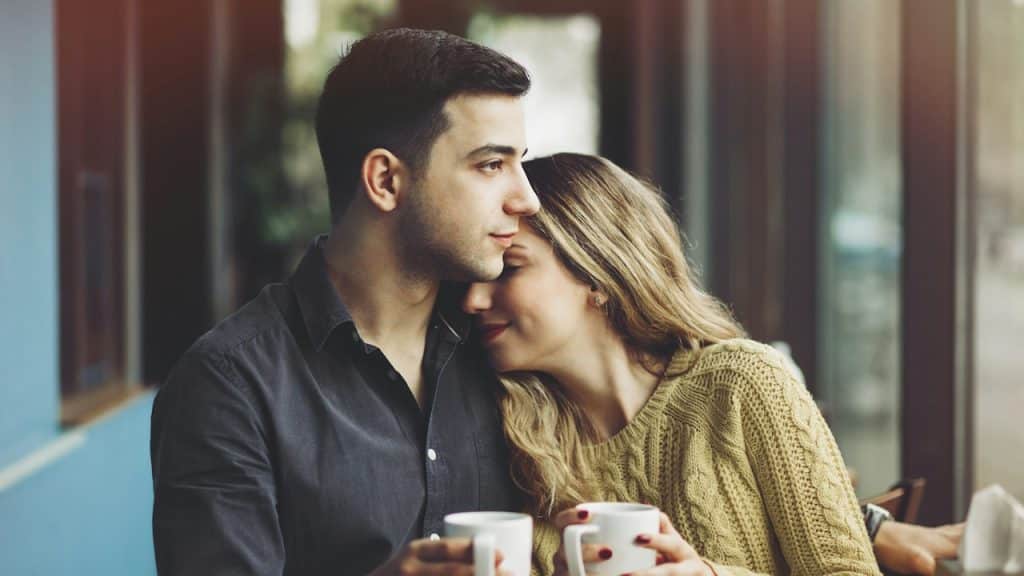 A couple in love drinking coffee and having fun in coffee shop love.
