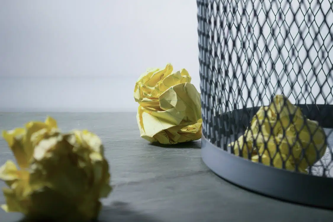 Yellow papers near trash bin