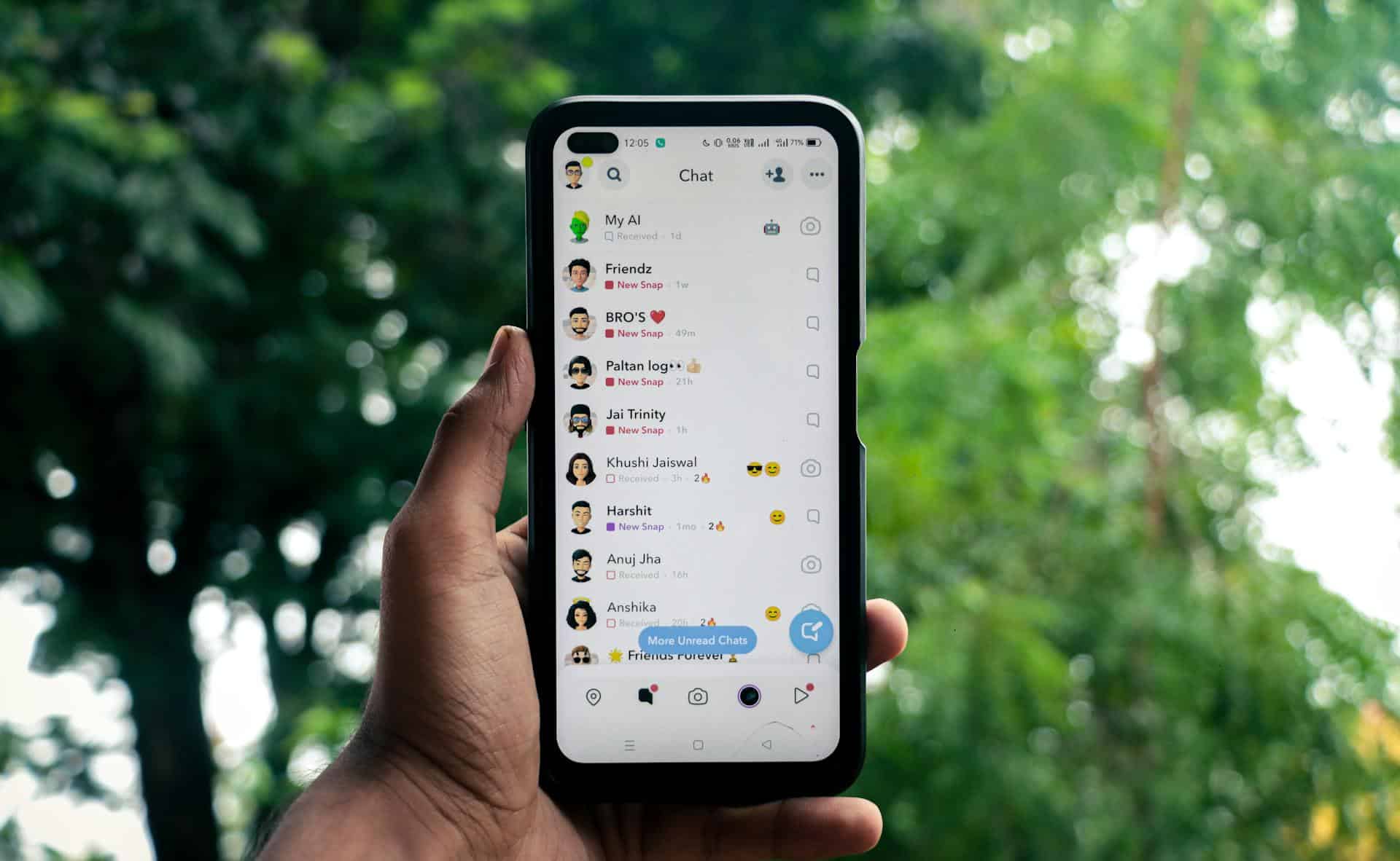 A man holding a phone with a social media app on the screen.