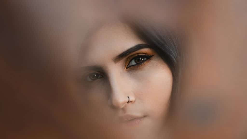 A woman staring out of a hole.