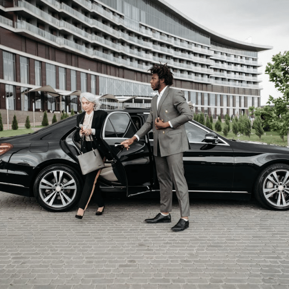 A man and a woman beside a car