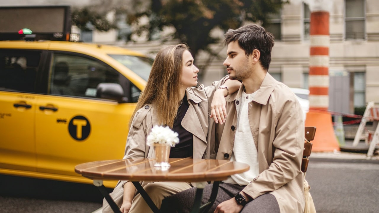 A man and a woman sitting with each other at a table.