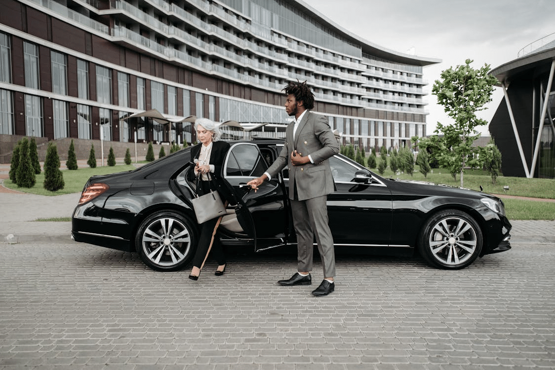 A man and a woman beside a car