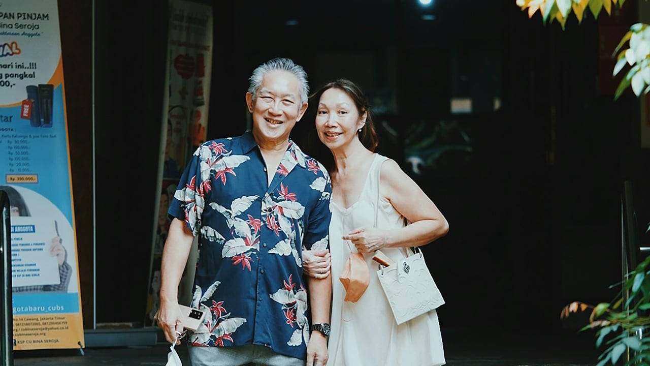 A man and woman standing in front of a building.