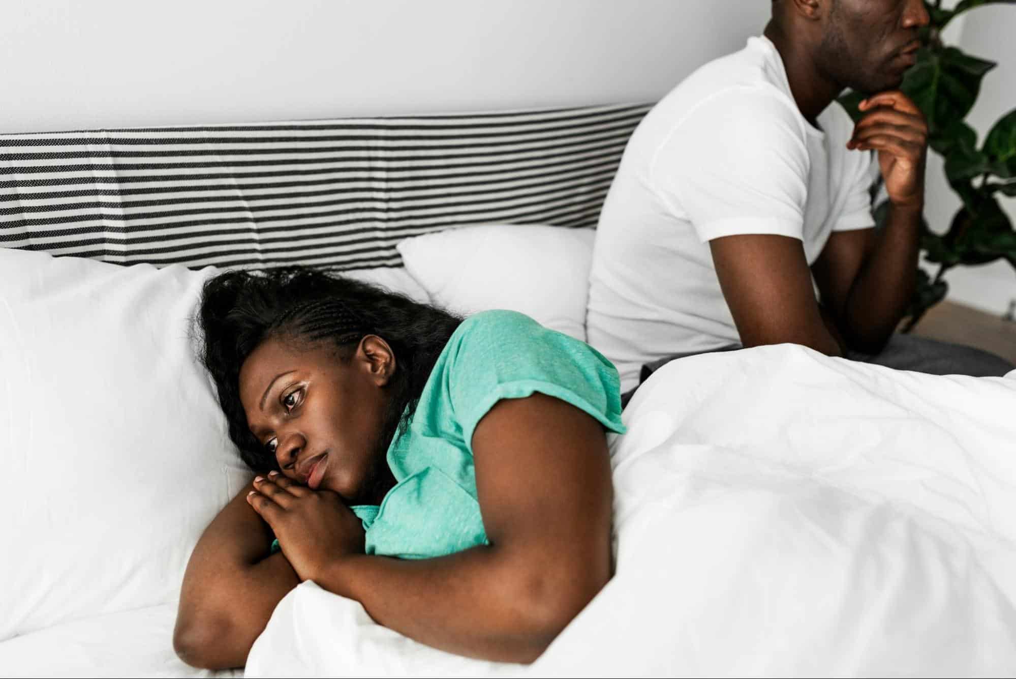 A woman lying in bed and staring nowhere 