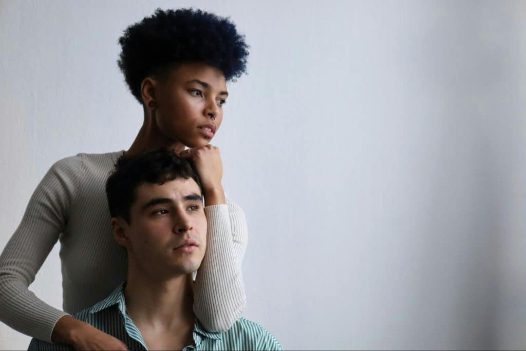 A woman holding a man’s shoulder