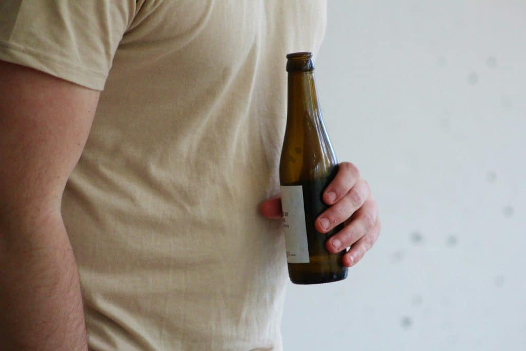 A man holding a bottle.