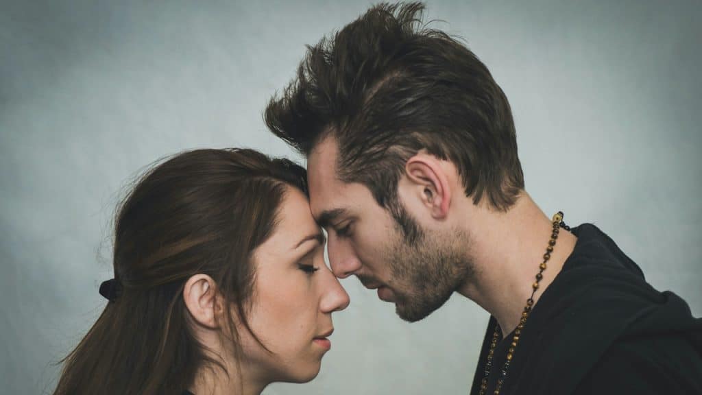 A man and a woman kissing each other.