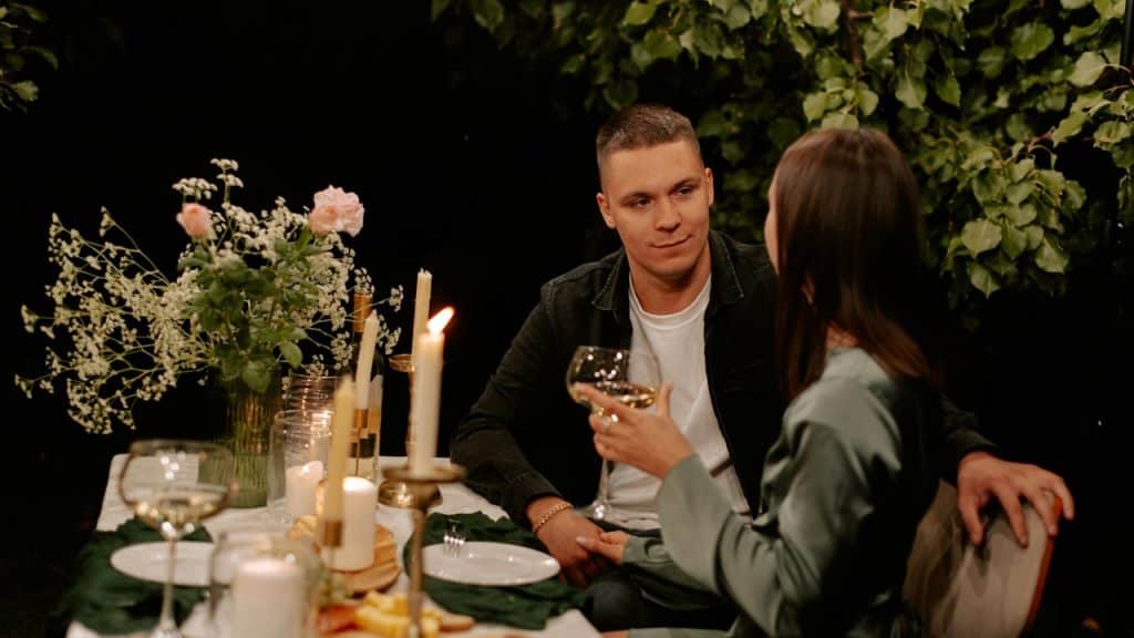 A man and a woman sitting at a dinner table.