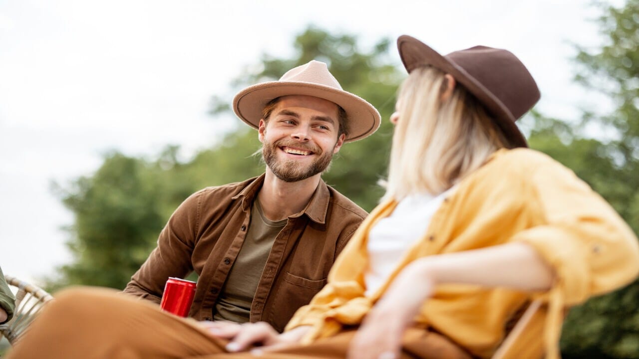 A couple talking outdoors while smiling