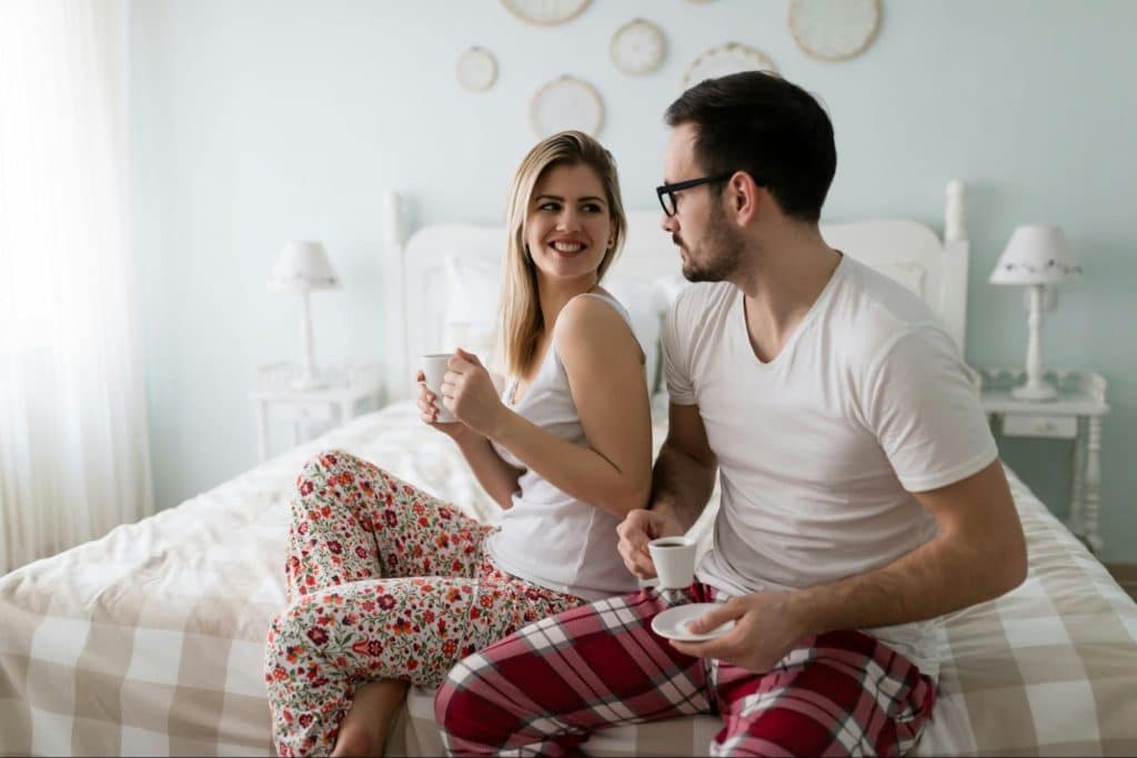 A man and woman at the bedroom