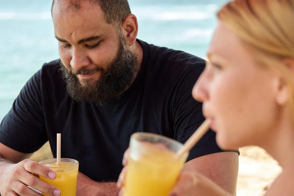 A couple having drinks by the beach.