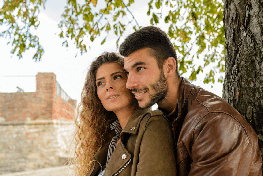 A man hugging the woman from behind
