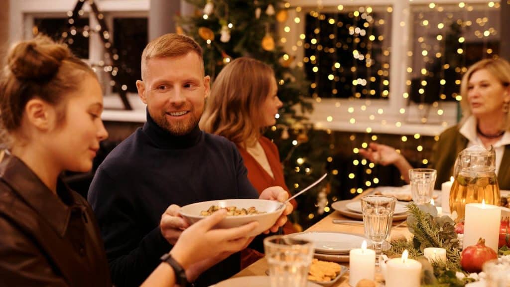 Family celebrating Christmas over dinner.