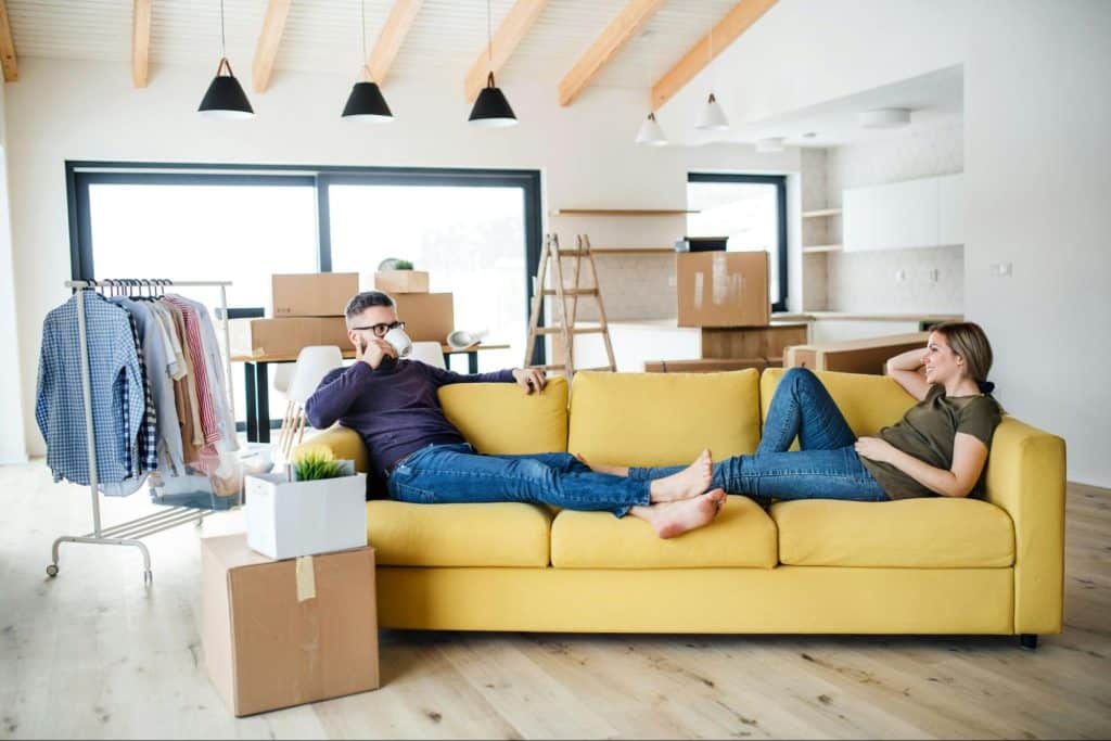 A man and woman relaxing at the sofa