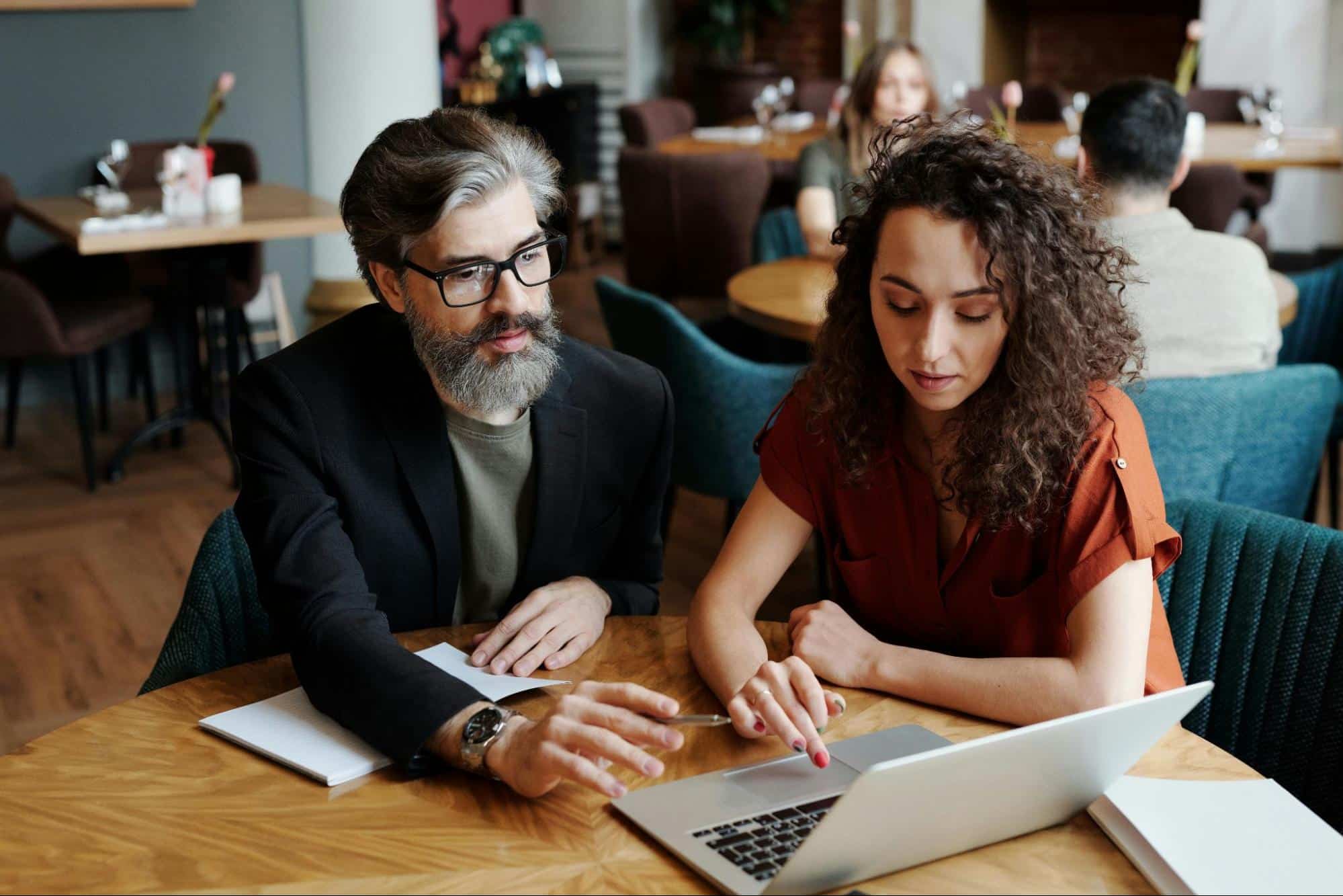 A man and woman checking something 