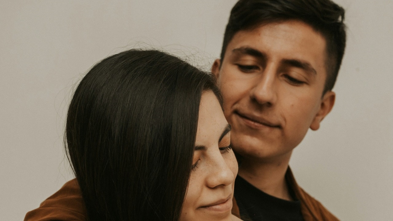 A man holding a woman close.
